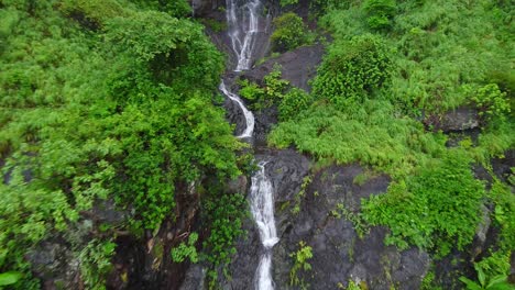 drone shot of beautiful waterfall on the hill