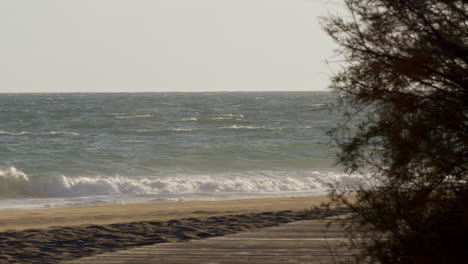 beach scene with wooden walkway
