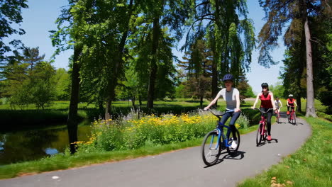 people cycling through a scenic park on a sunny day