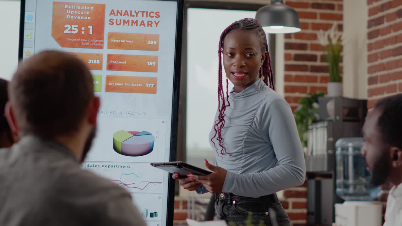 Close up of woman doing financial presentation at briefing meeting