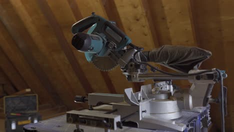 mitre saw with protective cover set in a woodworking shop, detailed shot capturing the essence of carpentry