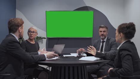 business consulting team looking at green screen, discussing project, teamwork