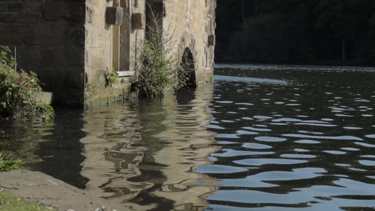 Newmillerdam Boathouse in England lake surrounded by water medium static shot