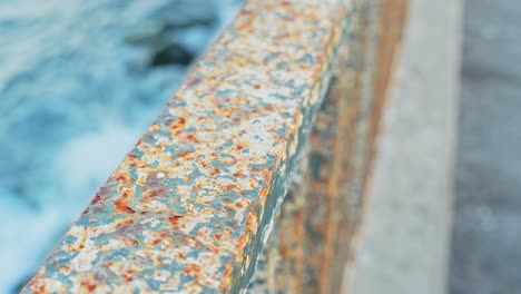 eroded handrail on atlantic ocean coastline, close up view