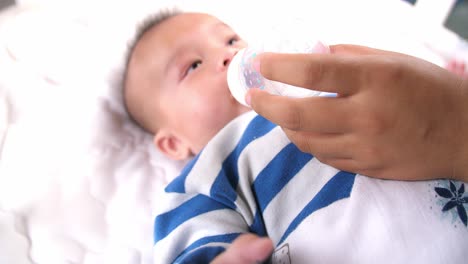 Mother Giving Baby Bottle With Water, Video In 4K