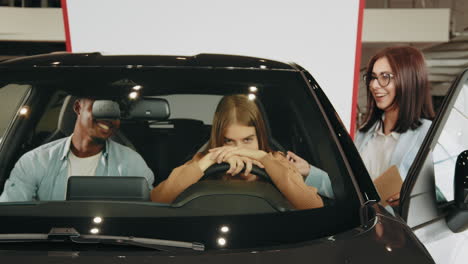 family test driving a new car in a showroom