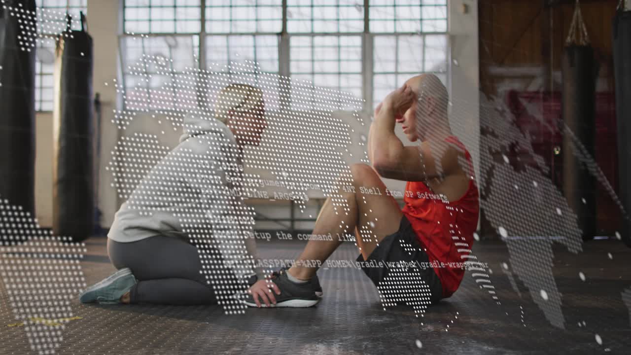 Coach holding feet cueing client in gym, client crunching building abs, code overlay obscuring view