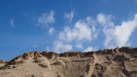 Time-lapse-of-light-clouds-floating-over-sand-dunes-at-Crantock-Beach