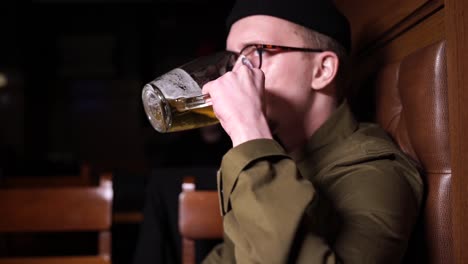 man drinking beer in a bar