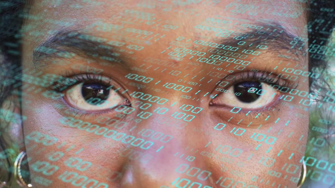 Binary digits appearing across face, woman opening eyes, shifting gaze, pupils reflecting tech code