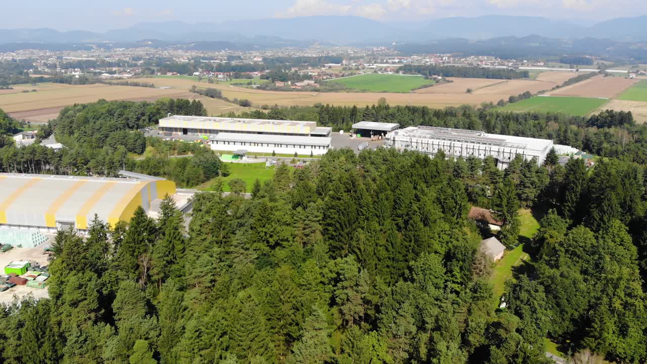 Approaching plastic recycling plant near a landfill area in eastern Europe, Aerial flyover view