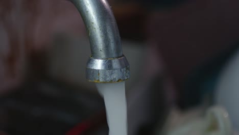 person rinses soap from clean dishes in daily lifestyle hygiene routine