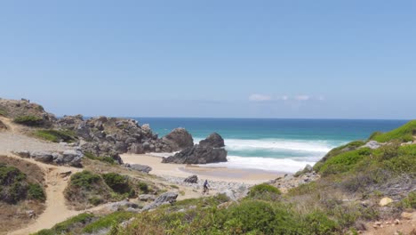 a mountain cyclist cycling by the beautiful portuguese coast with a blue ocean in the background