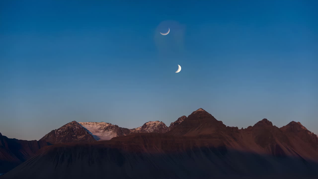 Mountains at night with two moons