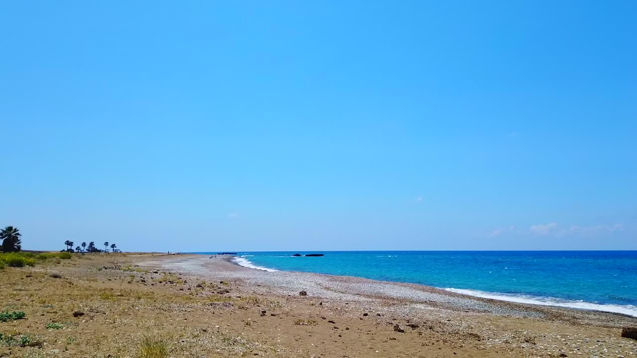 Gentle morning waves move across the shore at Mandria Beach, Cyprus. Soft light, peaceful water, and natural beauty—perfect for relaxation, travel, coastal, or mindfulness-themed footage.