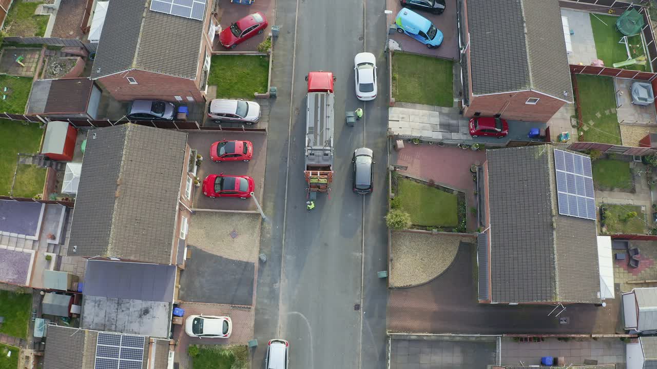 Premium stock video - A bin lorry, refuse collection vehicle makes it ...