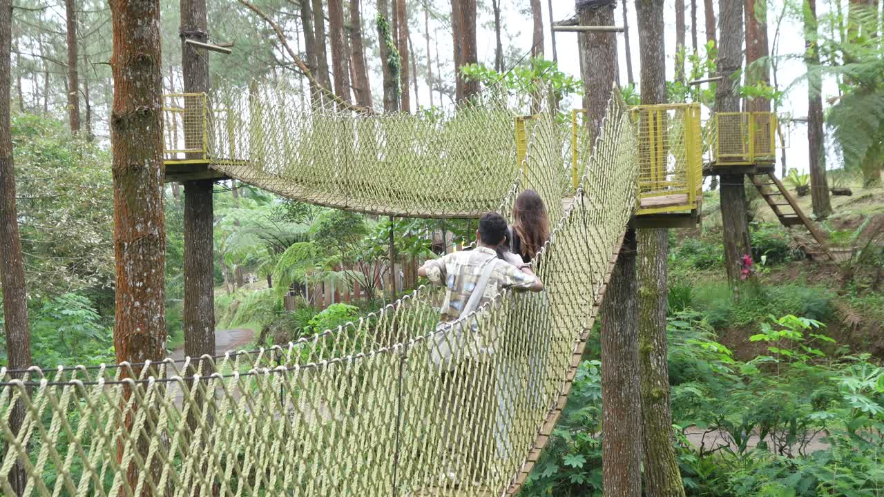Asian Friends Taking Selfie on Forest Rope Bridge in Indonesia