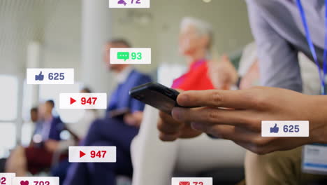 animation of media icons over caucasian businessman using smartphone