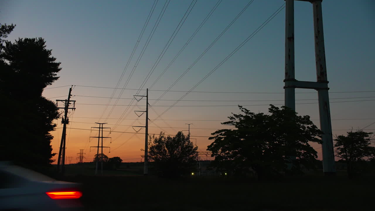 Electrical Power Lines in Silhouette at Sunrise in Pennsylvania USA