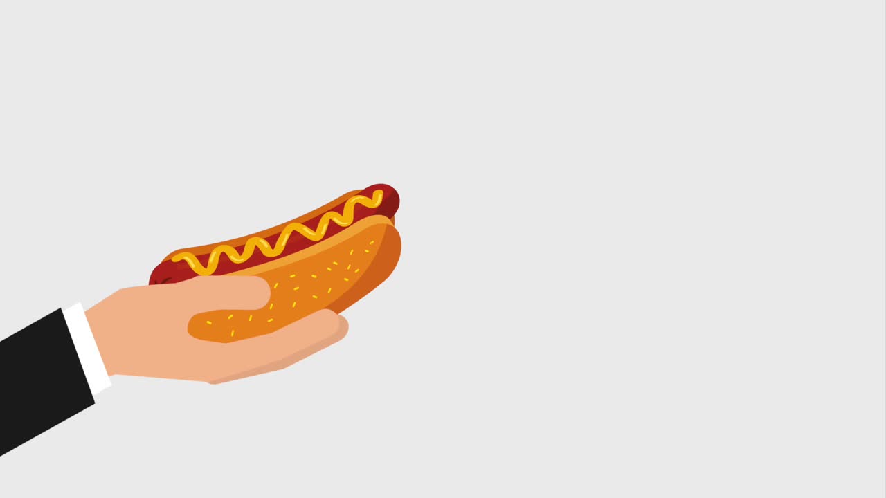 la mano sosteniendo el perrito caliente y vertiendo