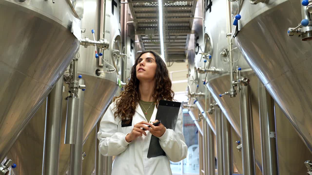 Woman Inspecting Brewery Tanks