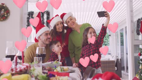animación de corazones sobre una feliz familia caucásica tomando una selfie
