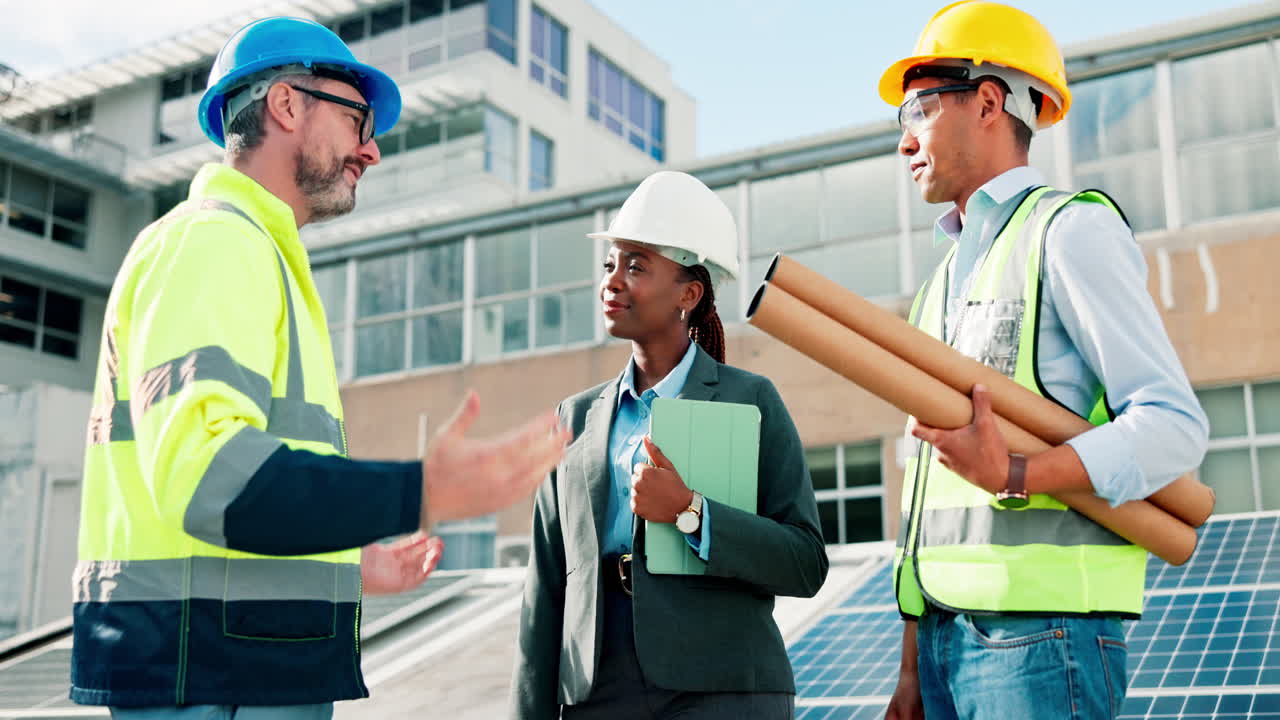 Team of Construction Workers Shaking Hands Near Solar Panels