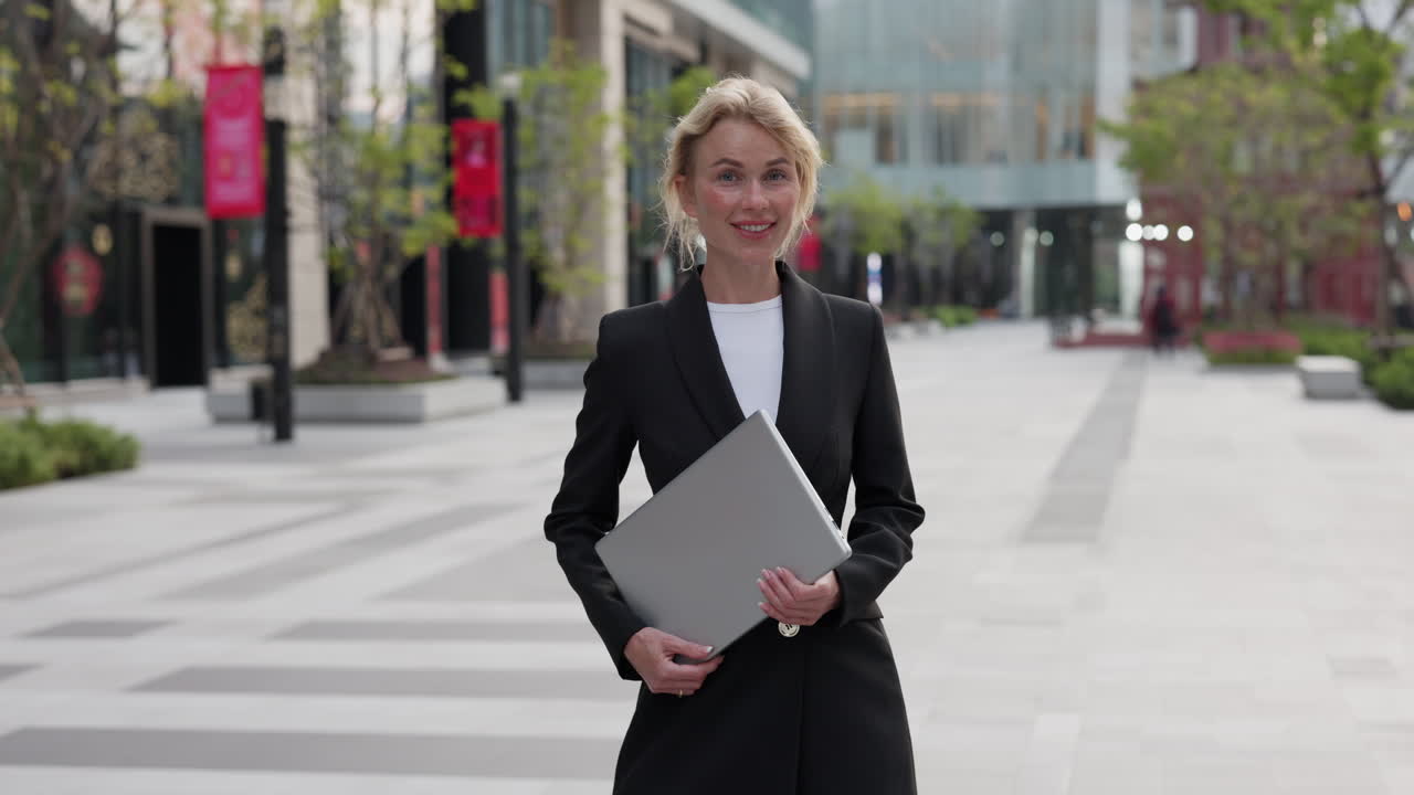 Businesswoman with Laptop in City