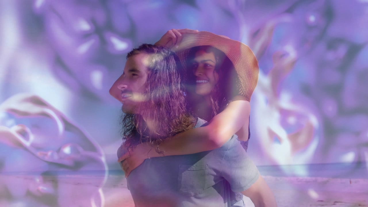 Man carrying woman on back at beach, purple bubble overlay washing over couple sharing travel ad