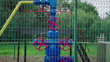 Handheld-dolly-out-shot-of-a-blue-enclosed-Natural-gas-pumping-station