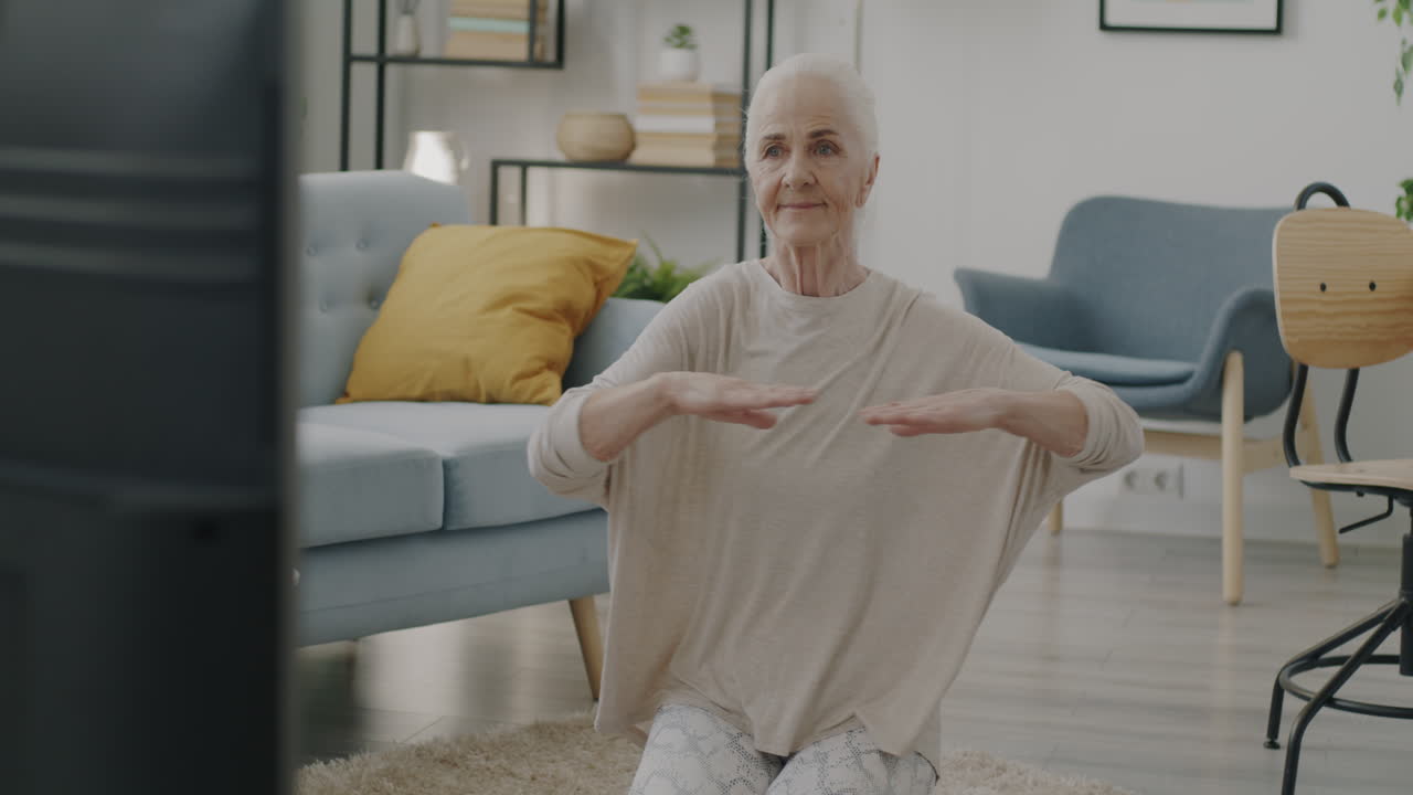 Senior woman doing yoga at home