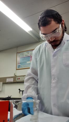 lab scientist with document and chemical setup