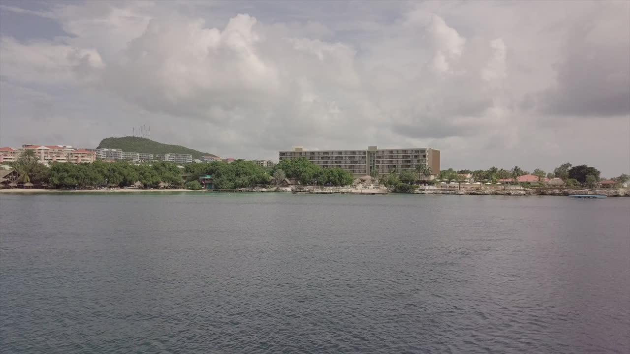 Una ripresa con drone panoramica sull'acqua calma verso la costa di Curaçao.
