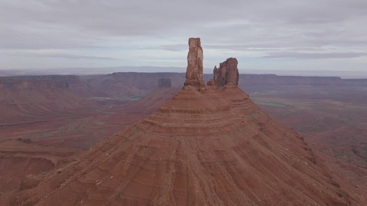 Majestic view of Moab's Castleton Tower under a cloudy sky in a serene setting