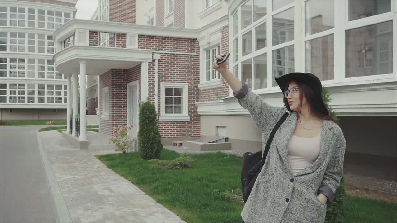 Young Woman Taking Selfie Outside Modern Building