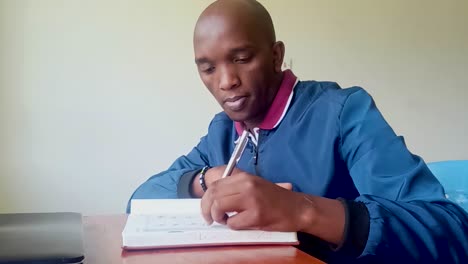 young black africa man reading in the house during ukraine-russia war