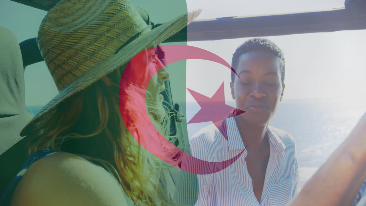 In car ride, two women waving Algerian flag with animation overlay