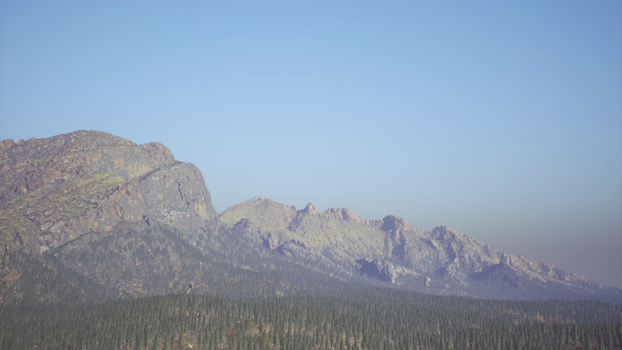Mountain range under clear blue sky at sunrise in natural landscape view