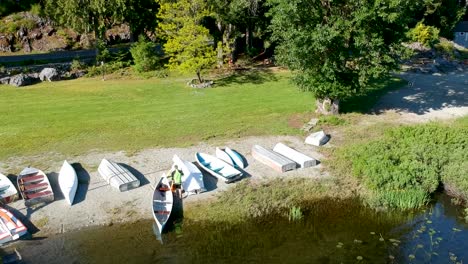 Man-getting-out-of-a-canoe-on-a-lake-in-BC-Canada