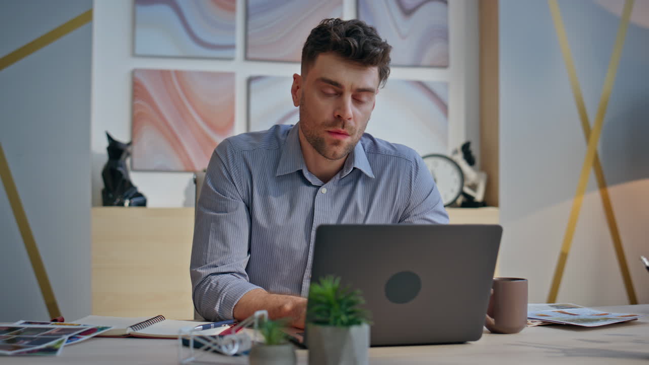 Overworked guy looking computer monitor at buro closeup. Man looking solution
