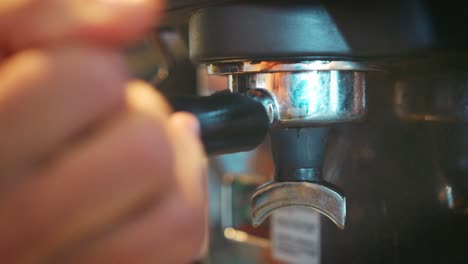 close up of male barista using coffee machine in cafe