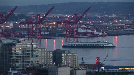 A-Cruise-Ship-Makes-Its-Way-Through-Seattle'S-Harbor-Surrounded-By-Warehouses-Drydocks-And-Buildings