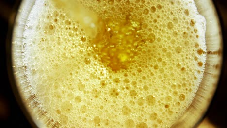 beer poured in glass against black background 4k