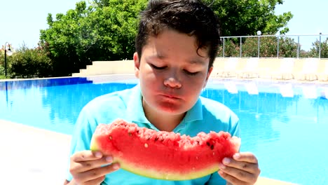 young boy eating watermelon