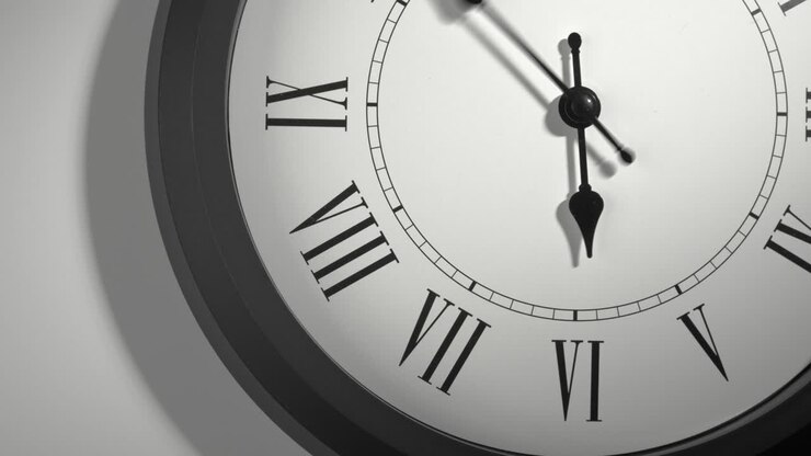 Latin Clock Face in Time Lapse on White Wall