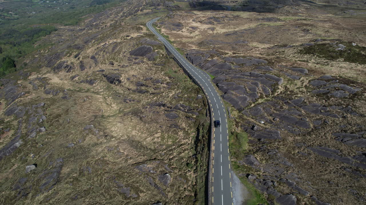 Drone Shot of Black Car Moving on Road in Caga Mountains, Cork County, Republic or Ireland