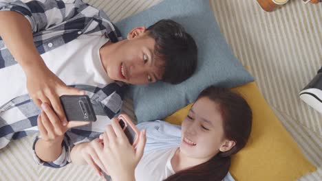 teenagers relaxing at home with phones