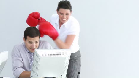 Competitive-businesswoman-hitting-her-colleague