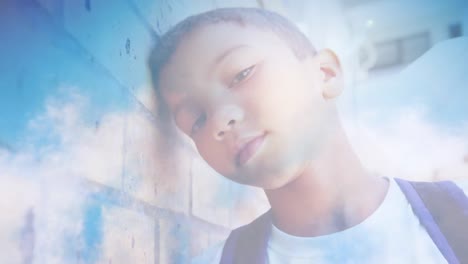 young boy leaning against wall