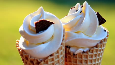 two vanilla ice cream cones with chocolate